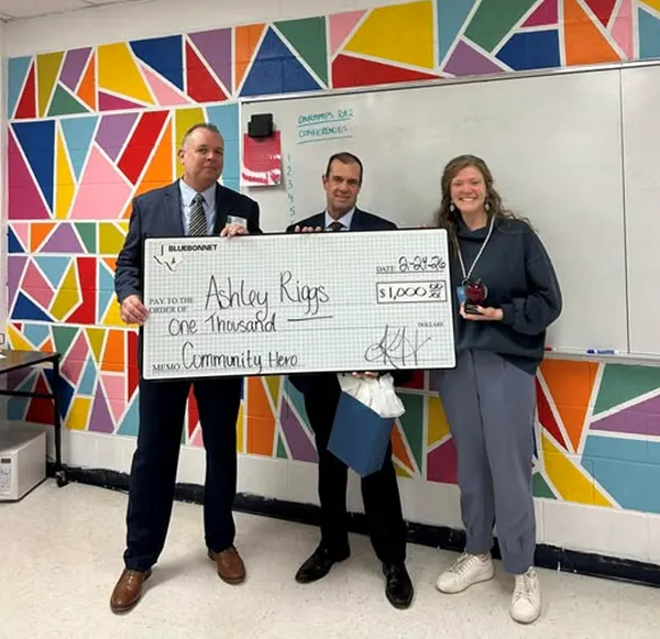 Ashley Riggs with Community Hero award